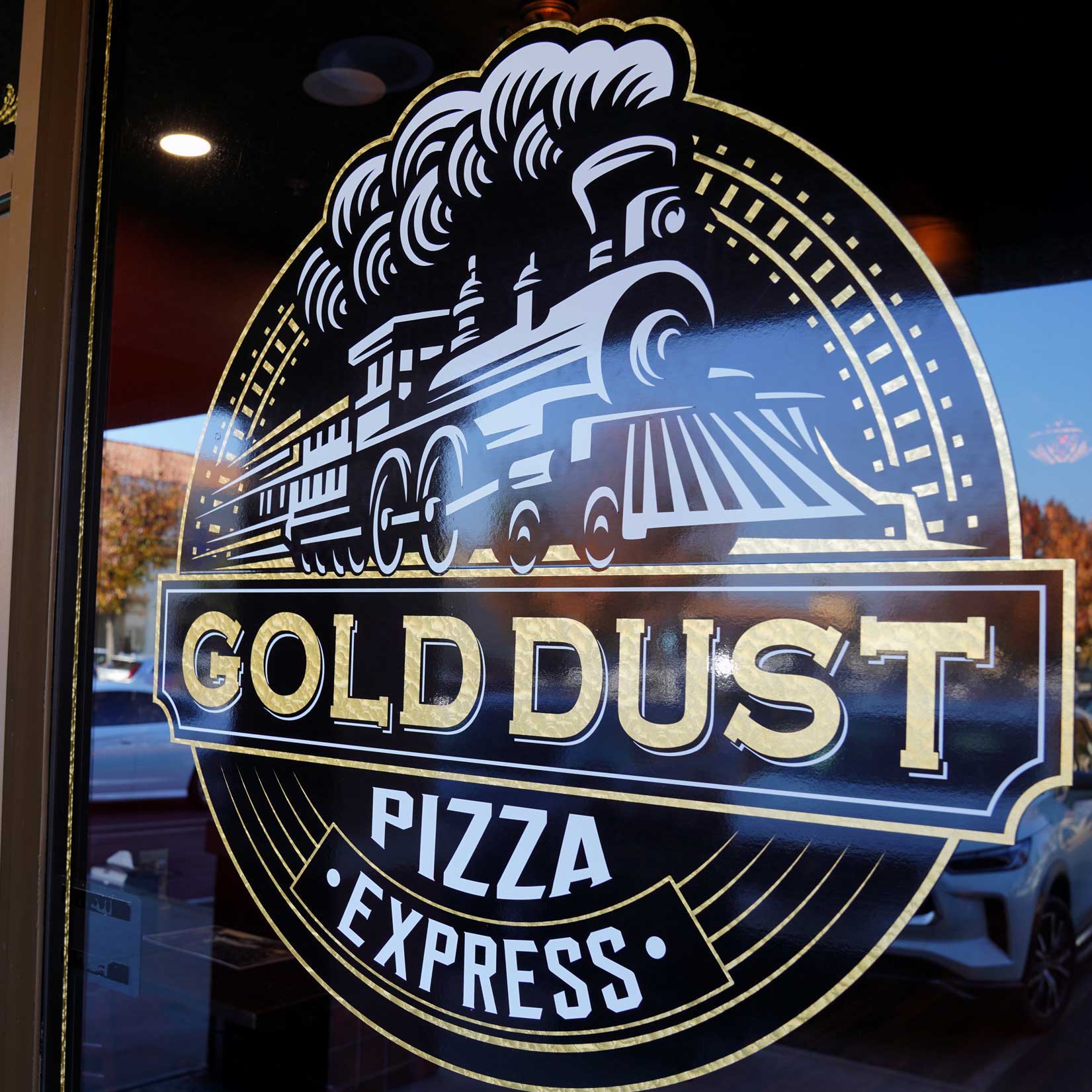Gold Dust Pizza Express storefront at night