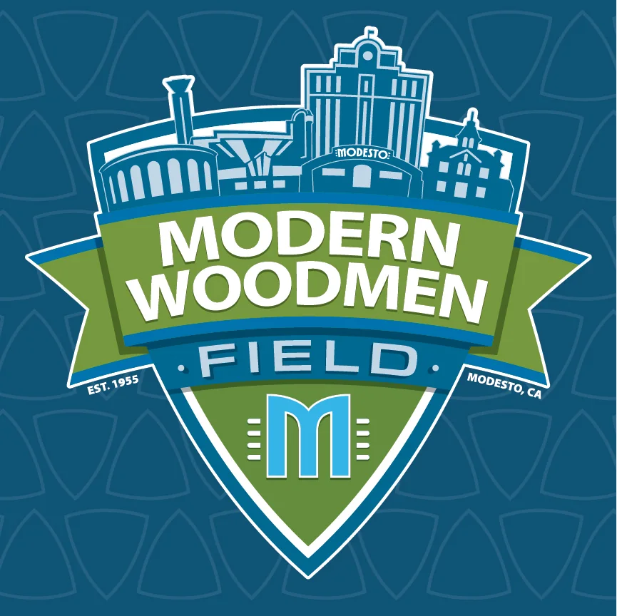 The approved Modern Woodmen Field identity: a shield carrying a simplified Modesto skyline above the words Modern Woodmen Field, with Est. 1955 and Modesto, CA on the banner and the Modern Woodmen M below