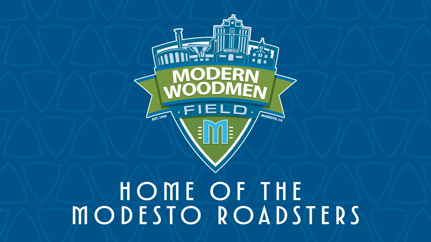 The Modern Woodmen Field scoreboard treatment: the shield above the words Home of the Modesto Roadsters on a blue patterned ground