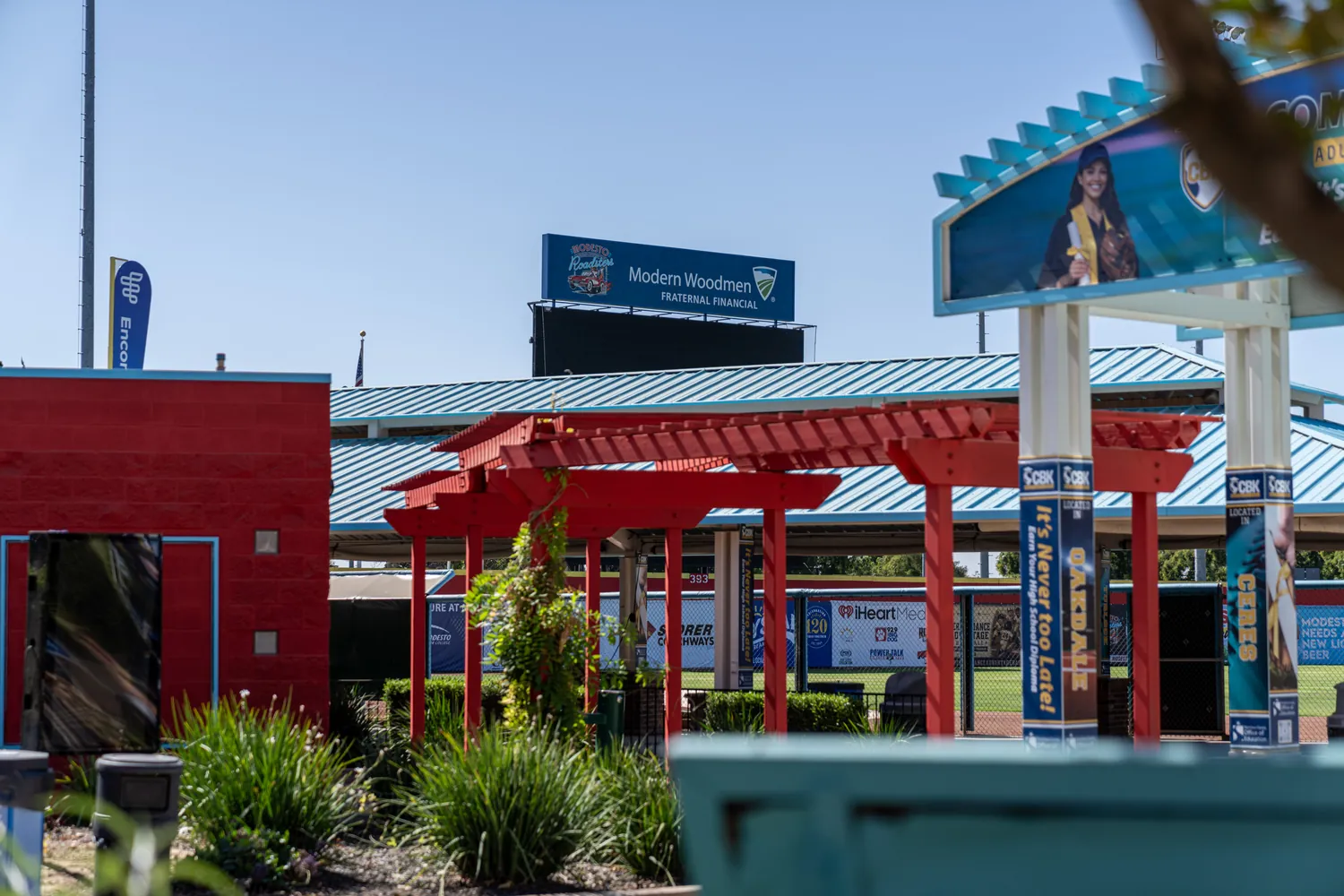 The Party Deck and its illuminated arch signs seen across the concourse planting.