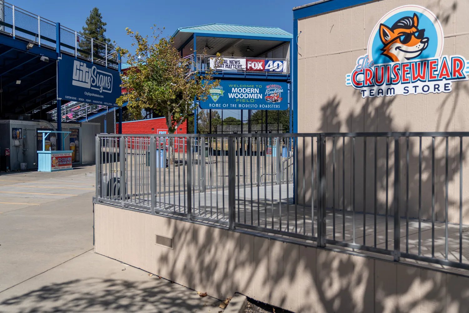 The team store and concourse signage under full daylight.