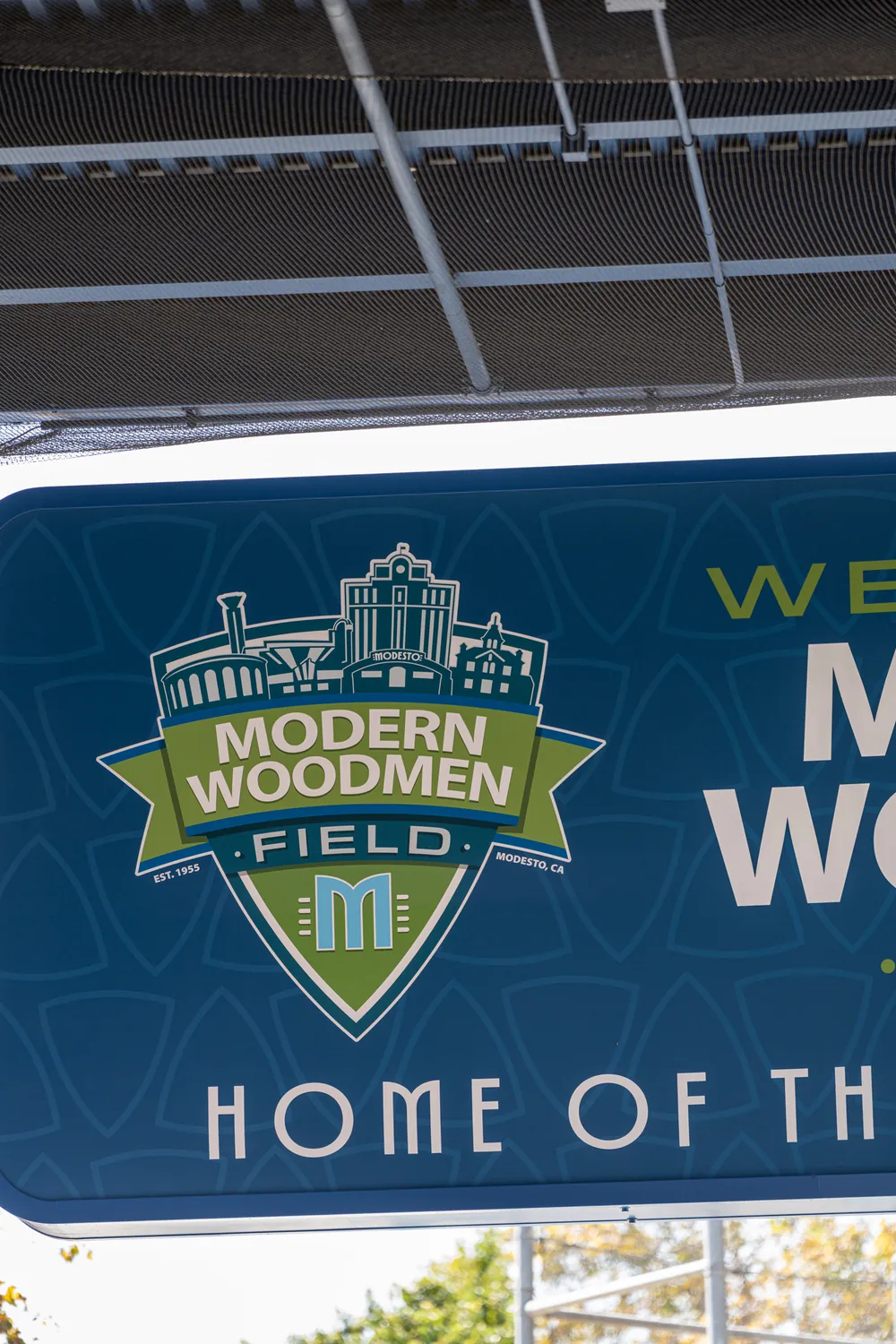 Close on the shield: the simplified Modesto skyline above the ballpark name.