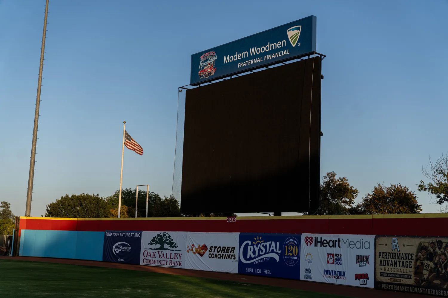 The scoreboard and flagpole as the light drops.